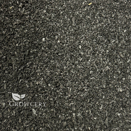 Pure Growcery Activated Biochar in a pile, showing its granular texture for carbon sequestration and toxin reduction in soil.