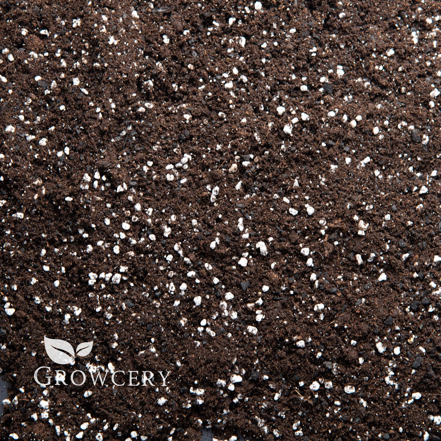 Close-up view of houseplant potting soil with biochar and perlite, ideal for indoor plant and garden soil use