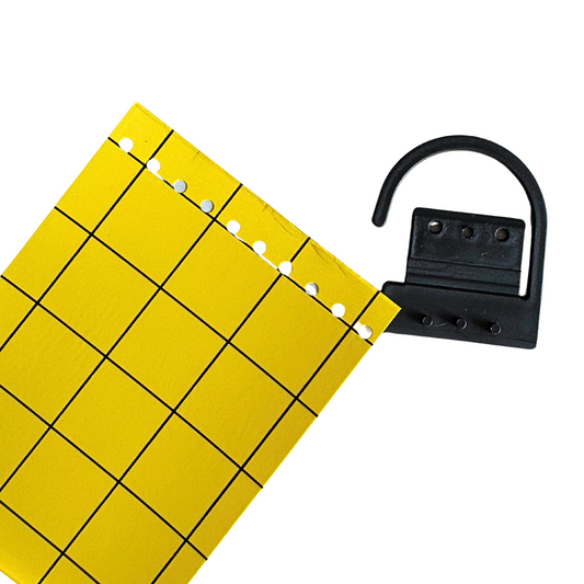 Yellow sticky insect trap being attached to reusable hanging hook