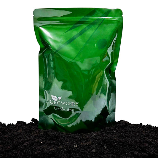 Green Growcery Gardening stand-up pouch displayed on a bed of dark worm castings against a white background.