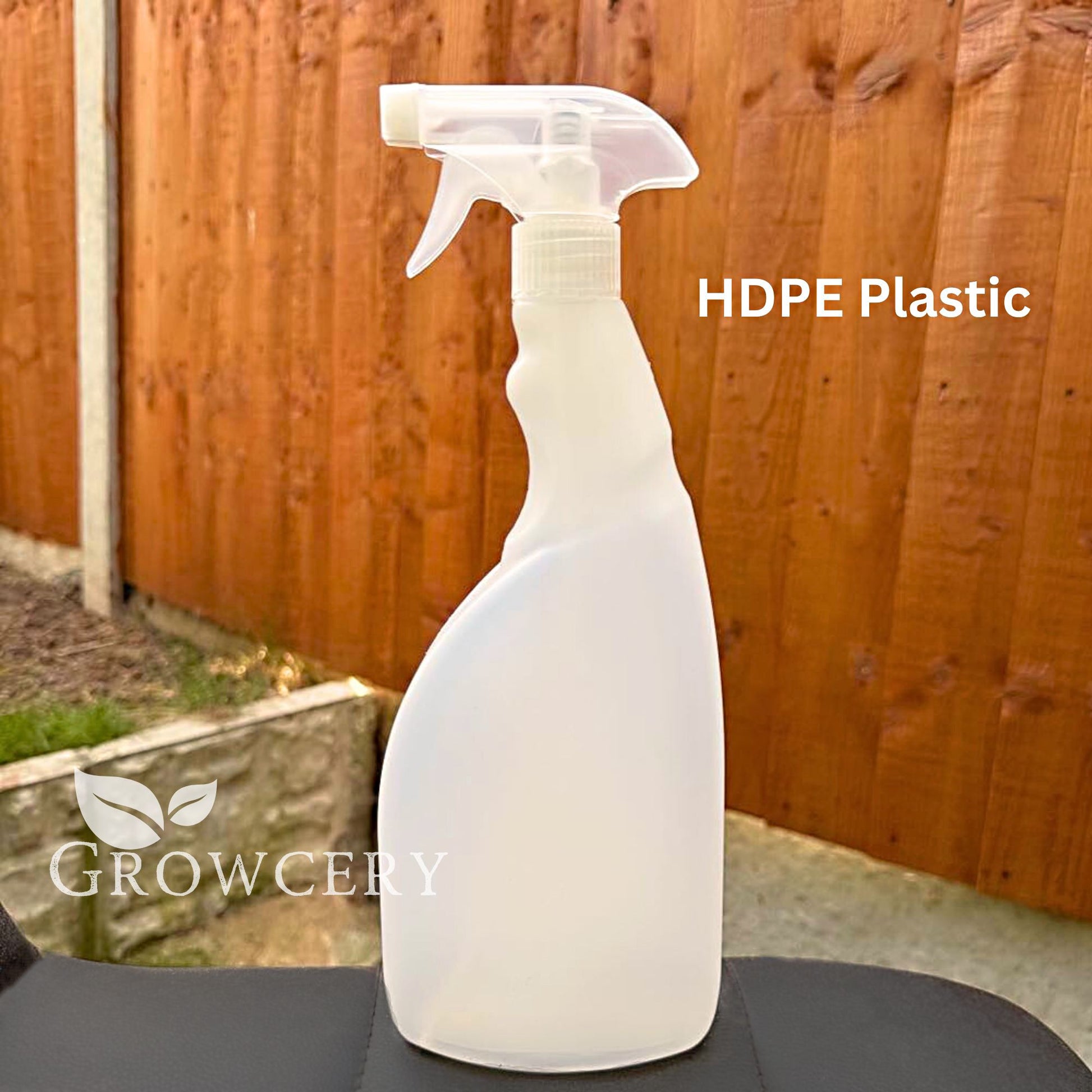 Clear-HDPE-750-ml-plant-sprayer-bottle-against-a-wooden-fence-background