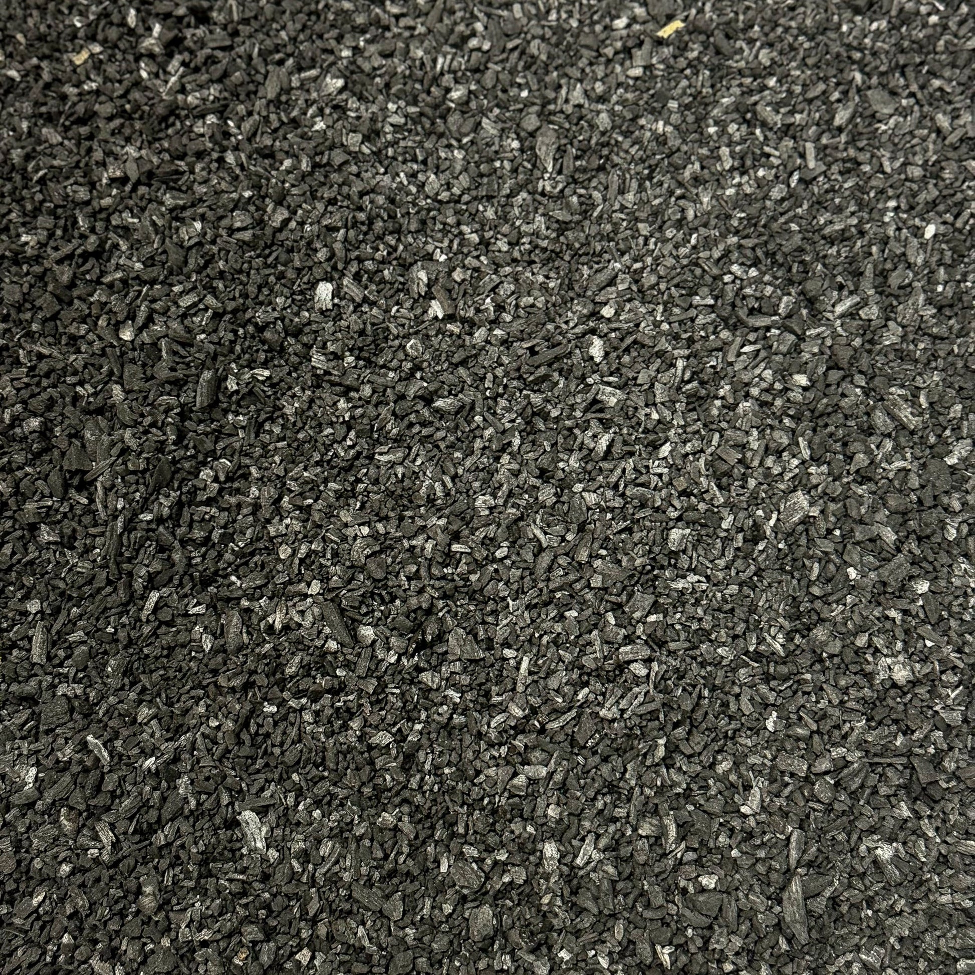 Pure Growcery Activated Biochar in a pile, showing its granular texture for carbon sequestration and toxin reduction in soil.