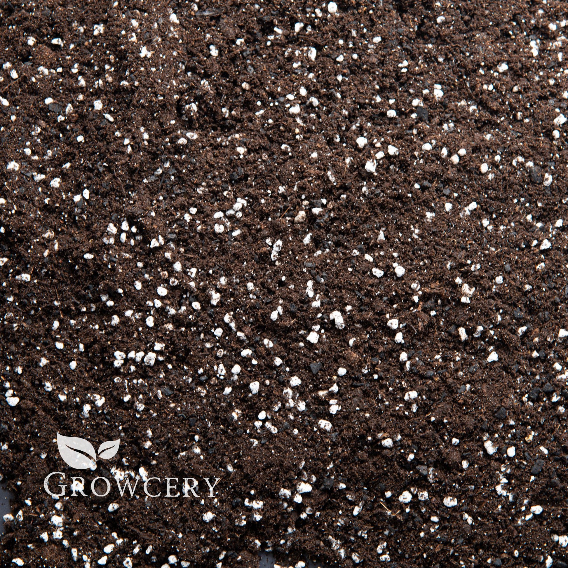 Close-up view of houseplant potting soil with biochar and perlite, ideal for indoor plant and garden soil use