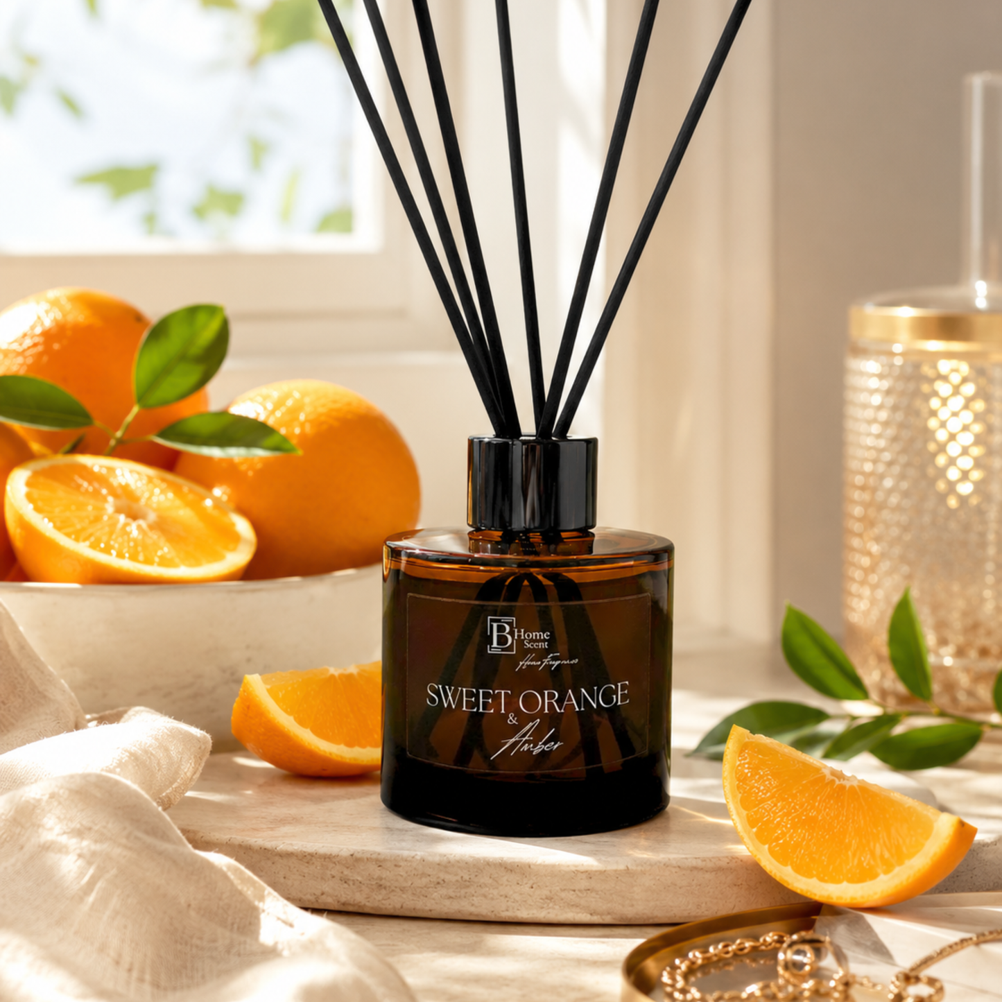 Sweet Orange and amber reed diffuser with oranges and leaves on a wooden surface