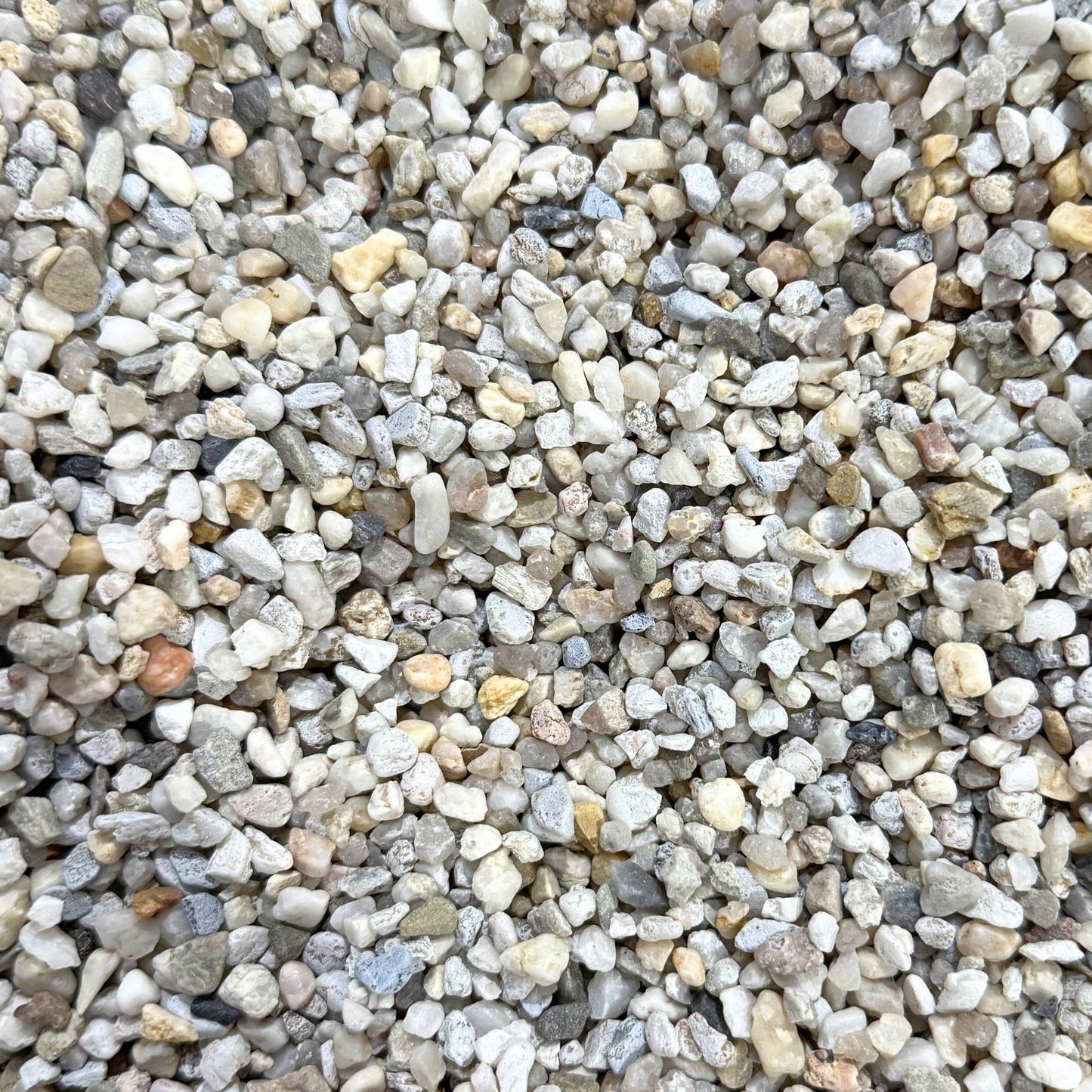 Detailed close-up of triple washed natural quartz aquarium gravel 3–5mm showing mixed light coloured rounded stones for fish tanks.