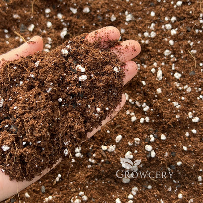 Hand holding universal houseplant mixmix for plants, showing airy and well-draining texture, branded Growcery